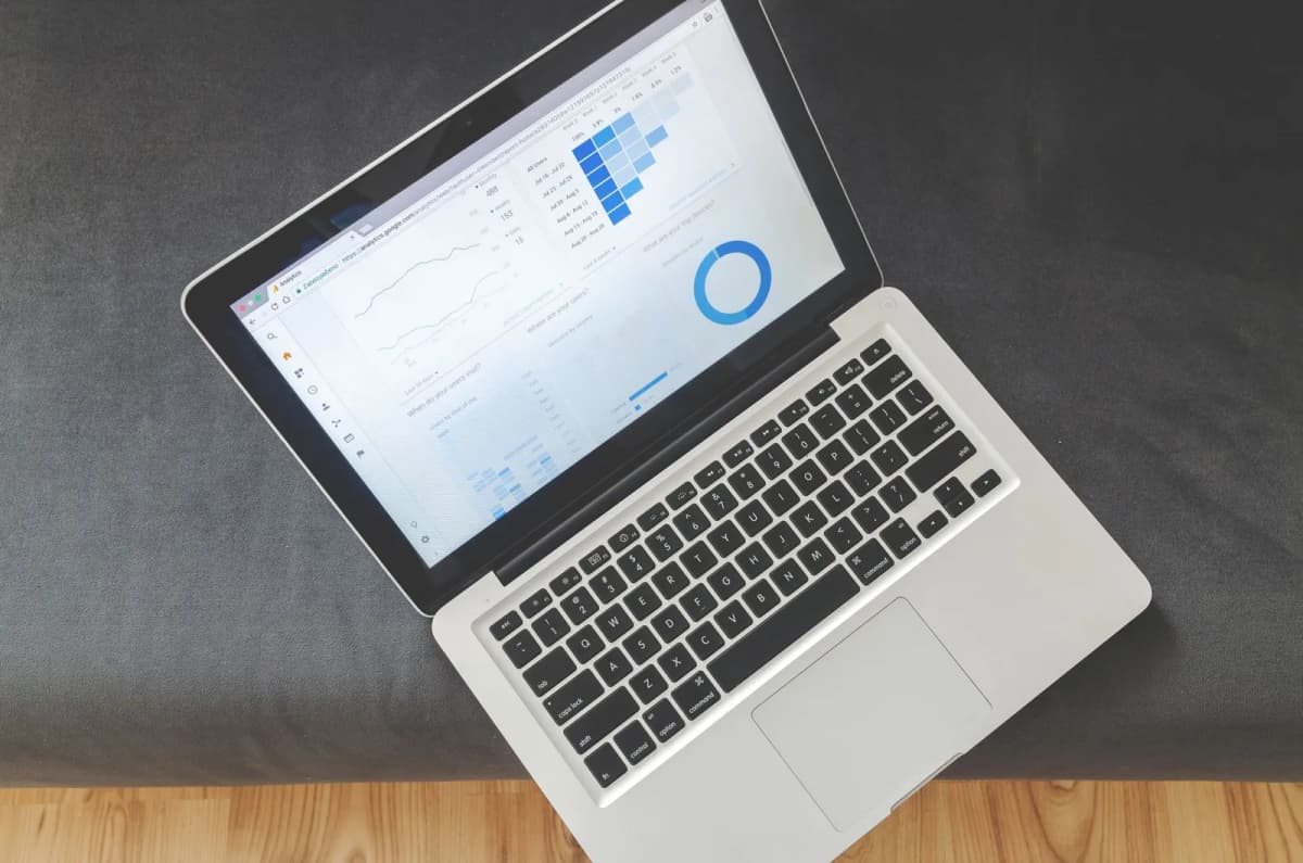 Overhead view of a laptop displaying data charts on screen