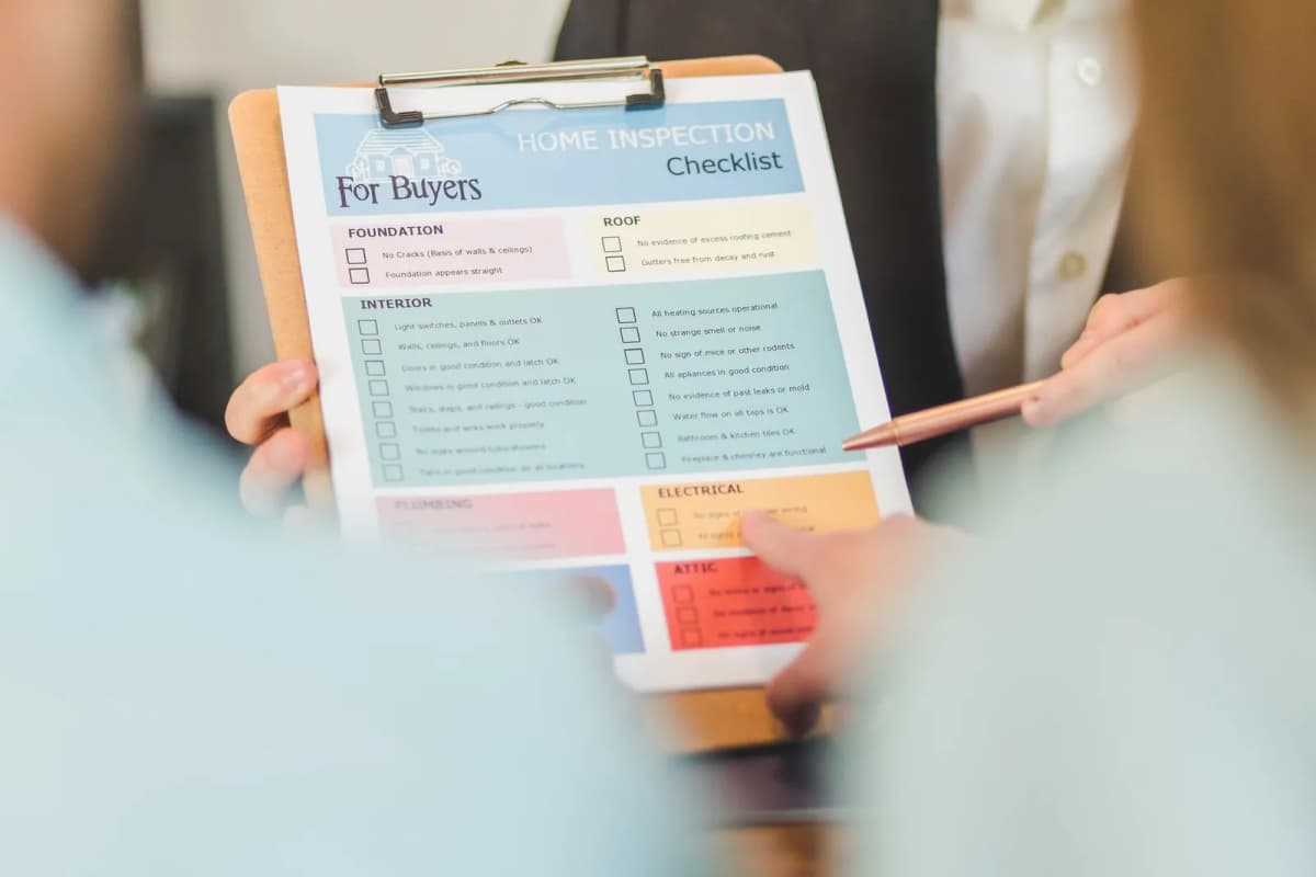 A hand holding an inspection checklist on a clipboard