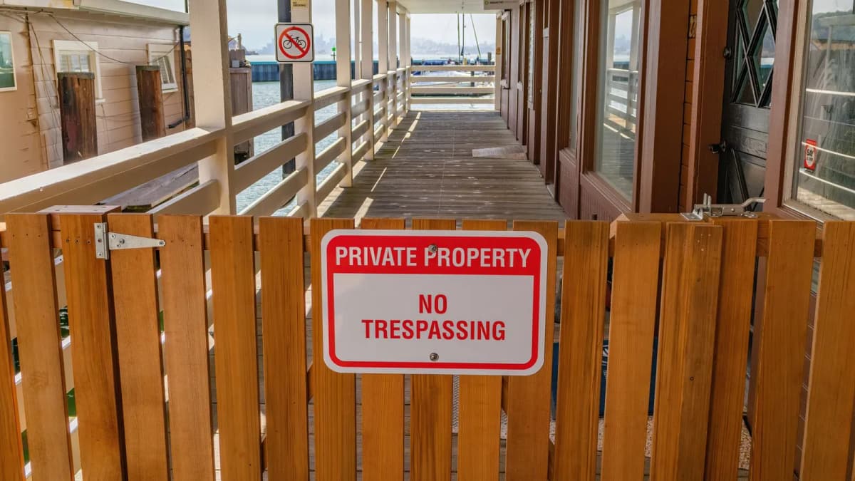 A wooden gate with a private property sign