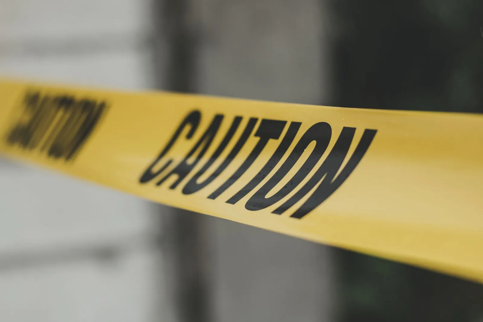 Yellow caution tape stretched across a work area