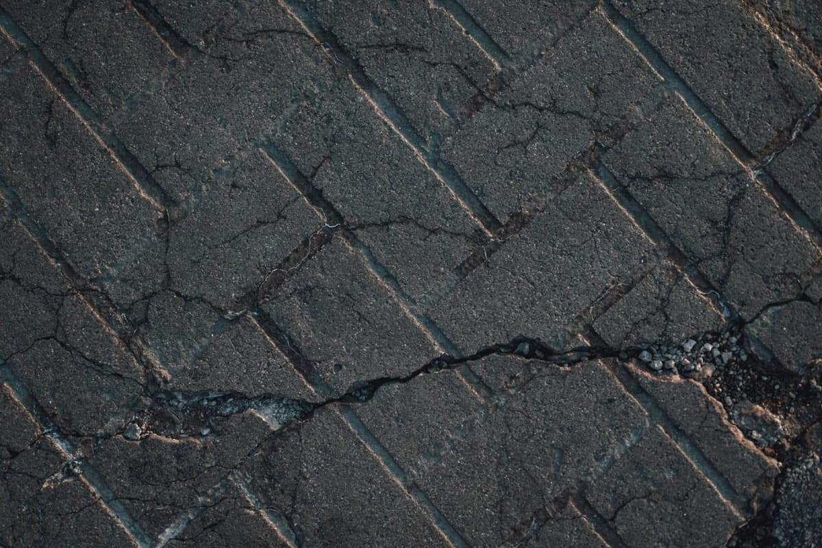 Cracked and broken pavement on a street surface