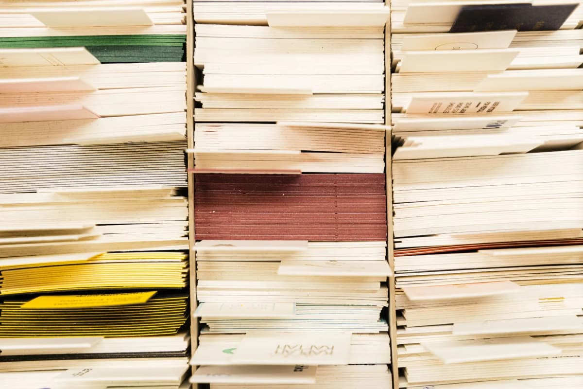 Stacked color-coded documents organized in a filing system