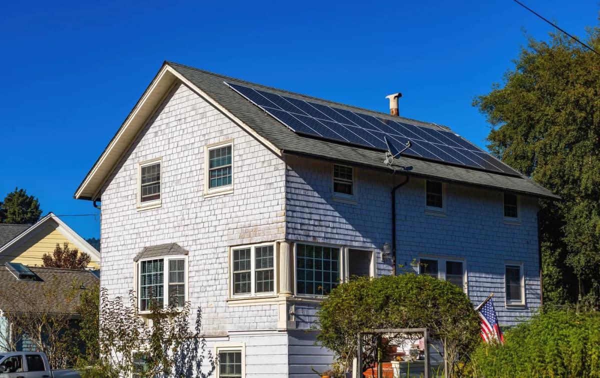 A single-family home with rooftop solar panels, the kind of exterior change an ARC reviews