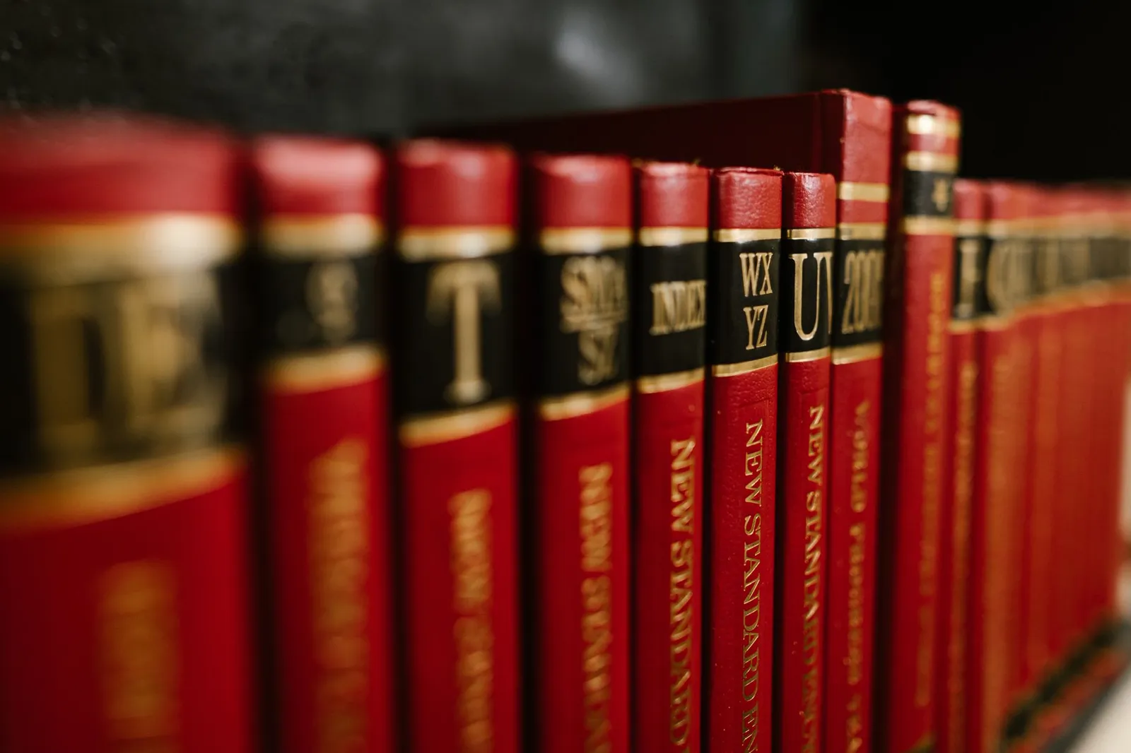A close-up of a shelf of bound reference volumes