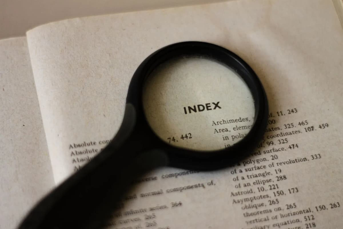 A magnifying glass held over a printed page, reading it line by line