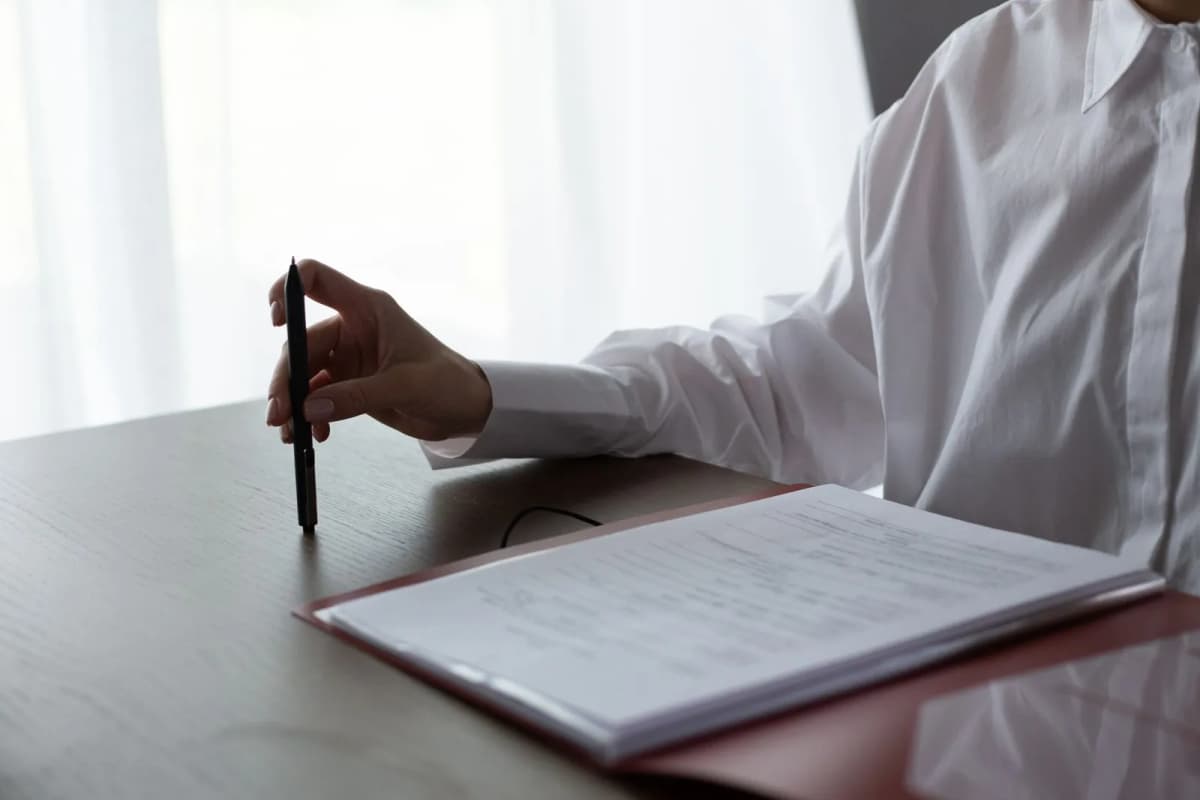 A board member going over a printed draft of the guidelines with a pen