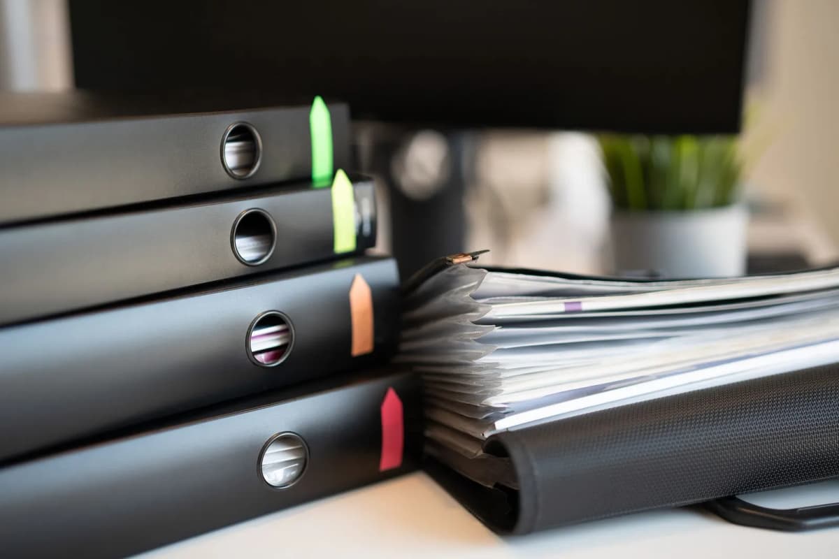 Binders of recorded governing documents on a board member's desk
