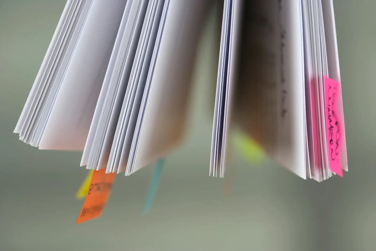Book pages marked with colored sticky tabs
