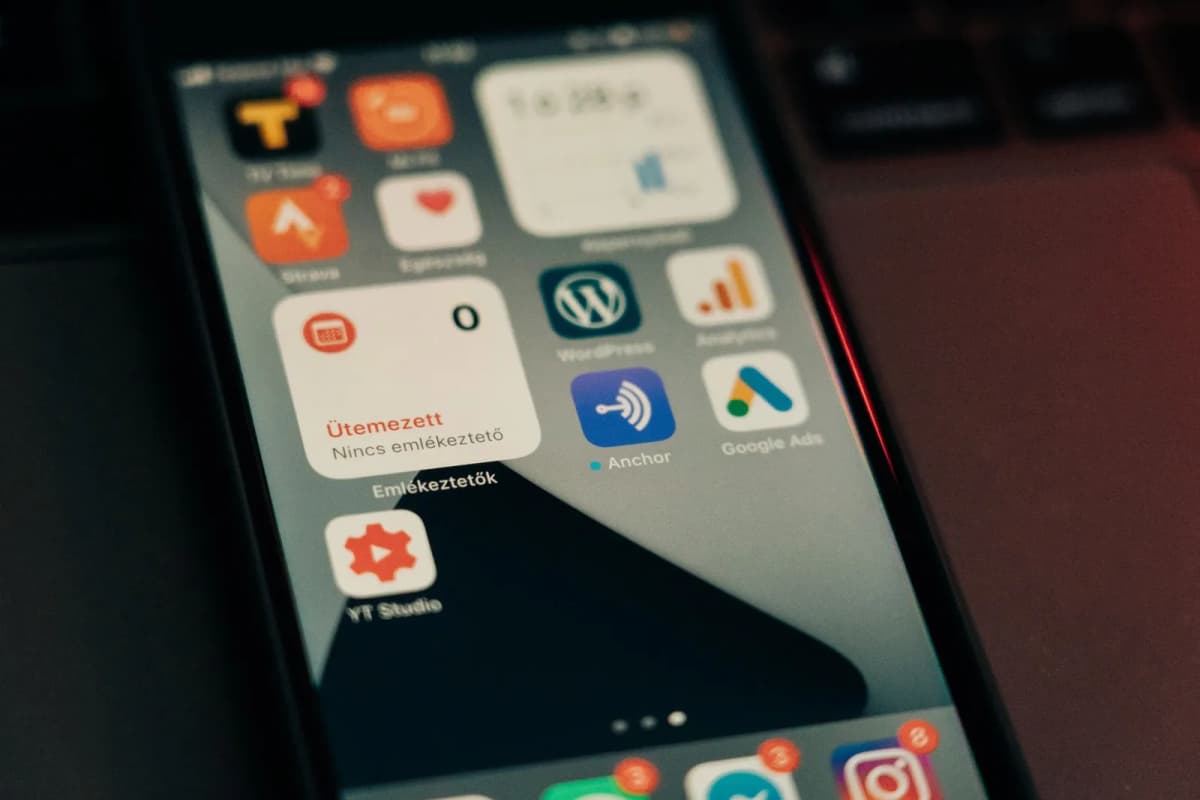 Close-up of a smartphone screen crowded with app icons and notification badges