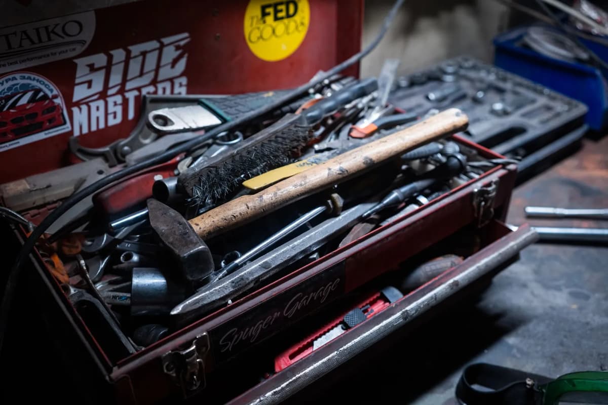 A toolbox filled with hand tools in a workshop