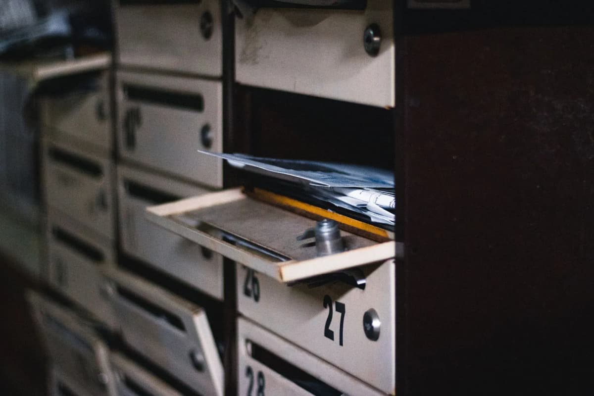 An open residential mailbox with mail inside
