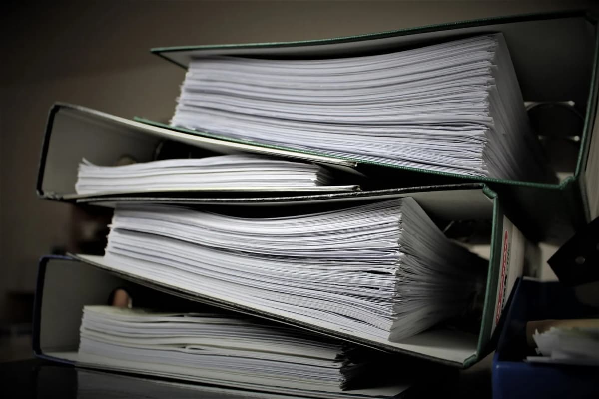 A stack of thick binders holding an association's governing documents