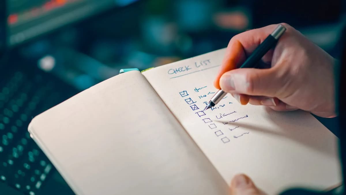 A hand writing in a notebook